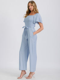 WOMEN'S SHORT SLEEVE SMOCKED FRONT POCKET BELTED CHAMBRAY JUMPSUIT