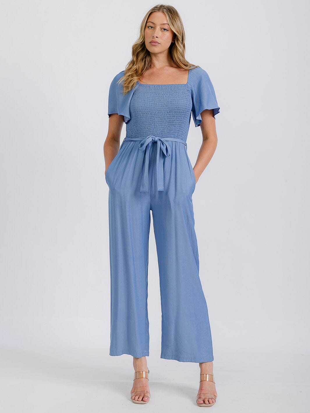 WOMEN'S SHORT SLEEVE SMOCKED FRONT POCKET BELTED CHAMBRAY JUMPSUIT