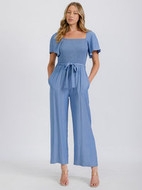 WOMEN'S SHORT SLEEVE SMOCKED FRONT POCKET BELTED CHAMBRAY JUMPSUIT