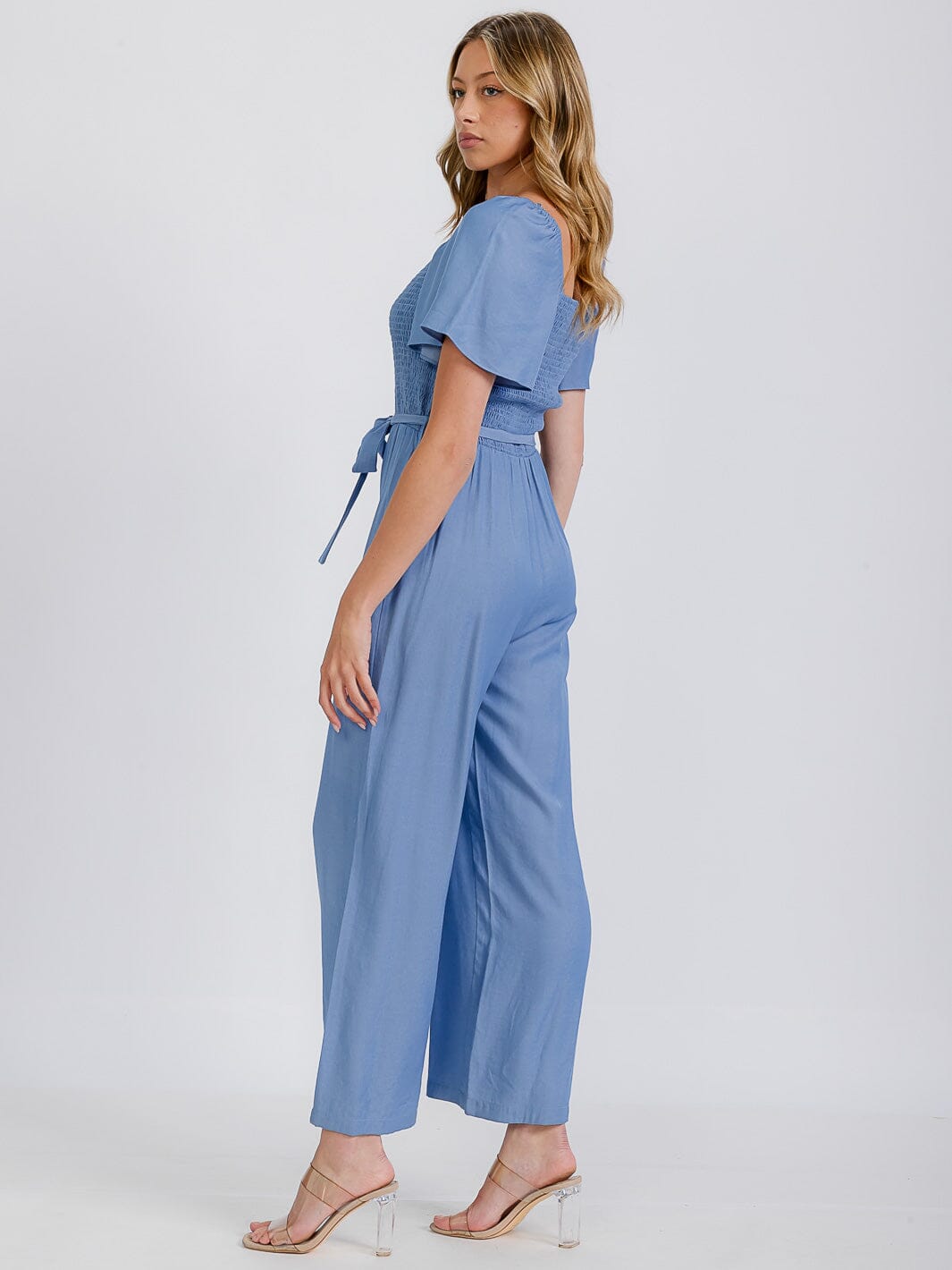 WOMEN'S SHORT SLEEVE SMOCKED FRONT POCKET BELTED CHAMBRAY JUMPSUIT