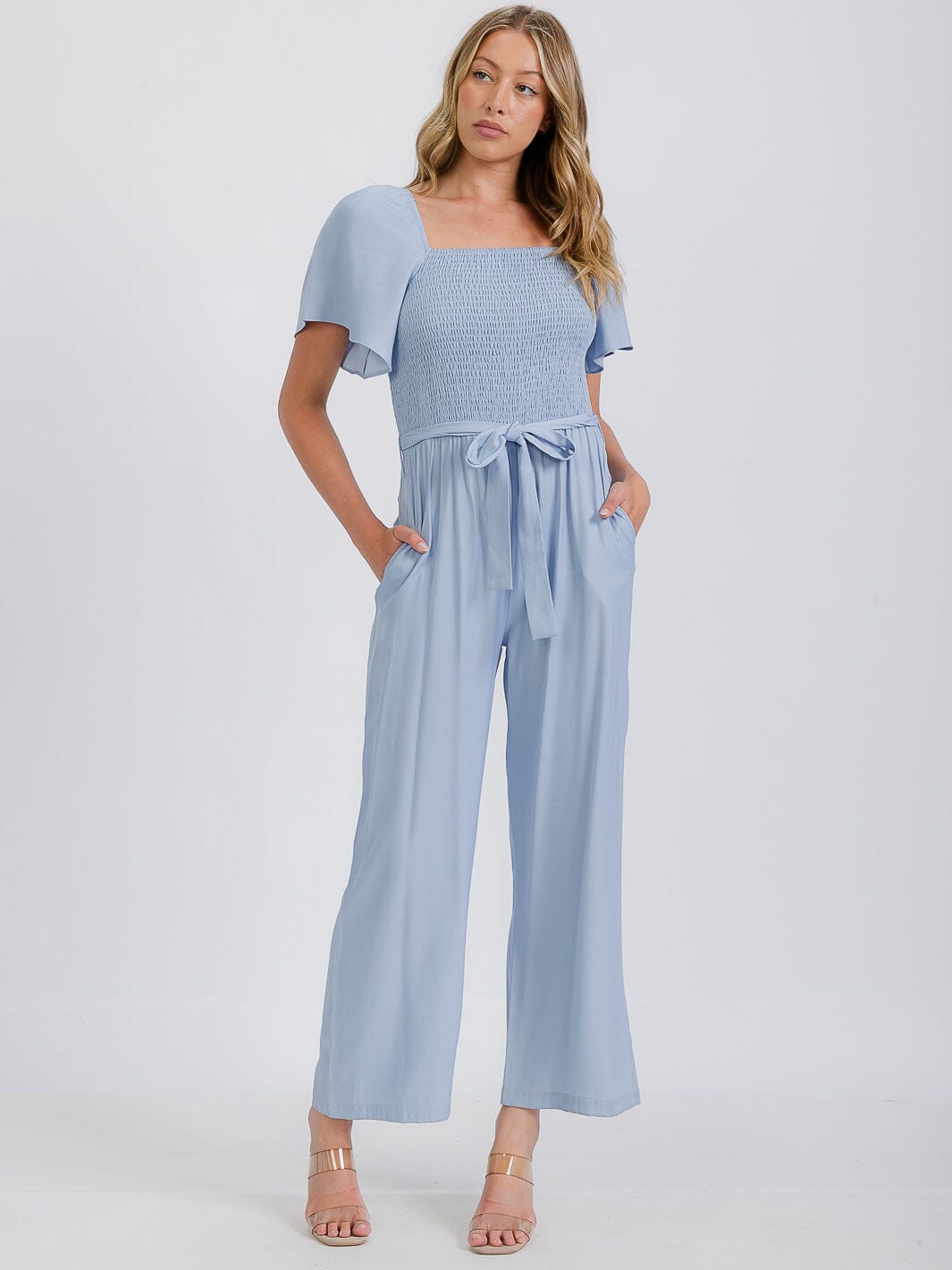 WOMEN'S SHORT SLEEVE SMOCKED FRONT POCKET BELTED CHAMBRAY JUMPSUIT